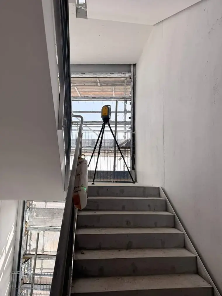 Laser scanner set up on a concrete stair core during construction